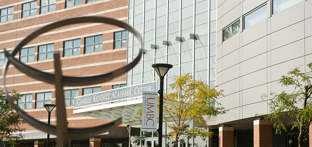 Exterior of Camille Kendall Academic Center with UMBC Banner in foreground.